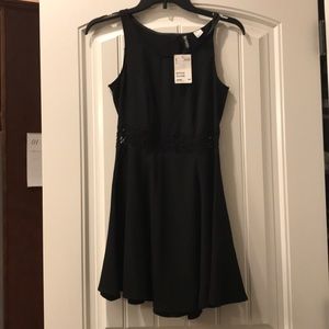 Black skater dress with lace in the mid area